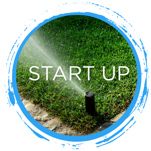 Lawn sprinkler head spraying water on green grass with "START UP" text for Hudson Irrigation and Lighting spring maintenance services in Surrey.